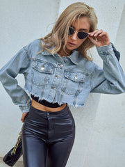 Light wash denim trucker jacket with raw hem and distressed details.