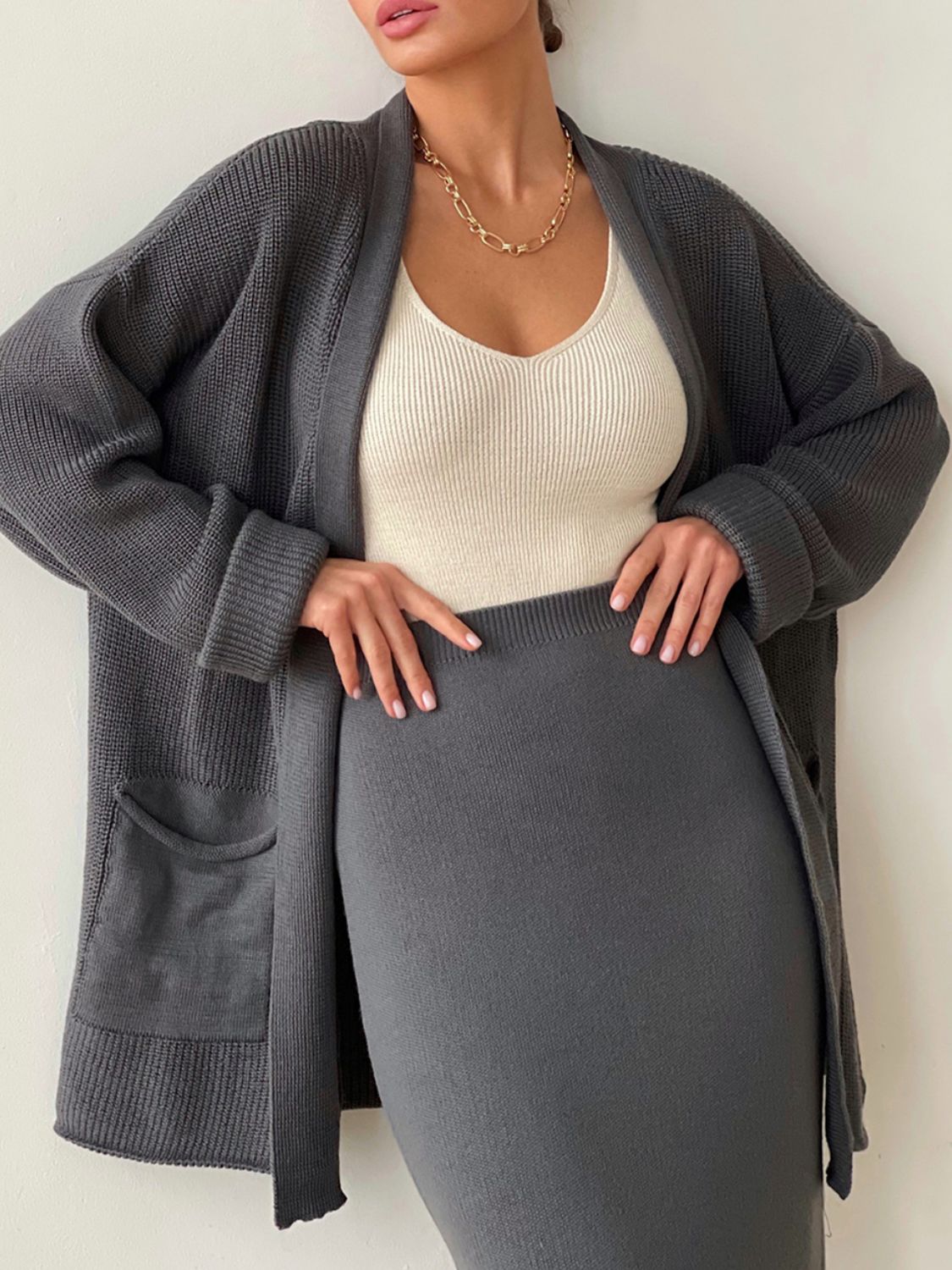 Dark gray ribbed knit cardigan and skirt set with cream ribbed tank top.