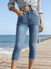 Sky blue cotton capri jeans with raw hem and pockets.