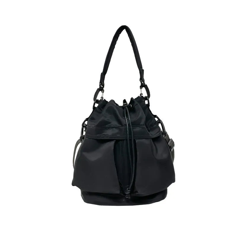 Black nylon drawstring bucket bag with chain detail and front pockets