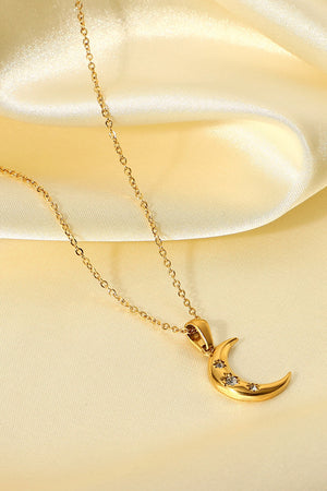 Gold celestial crescent pendant necklace with sparkling star details.