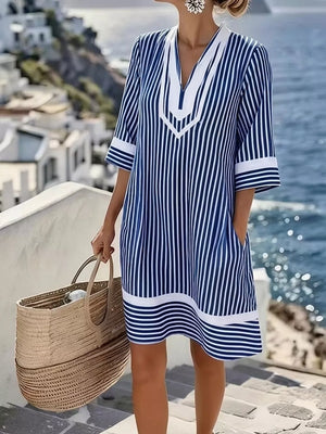 Blue and white striped V-neck dress with pockets and 3/4 sleeves.