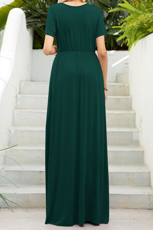 Forest green gathered waist maxi dress with pockets, short sleeves, and round neckline.