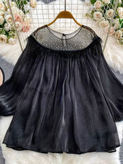 Black sheer blouse with rhinestone embellishments and feather trim.