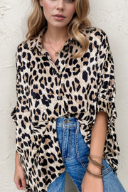 Leopard print oversized button-down blouse with a relaxed fit and collared neckline.