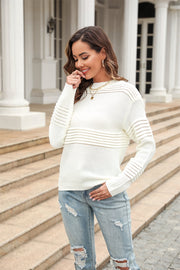 White openwork ribbed knit sweater with crew neck and long sleeves.