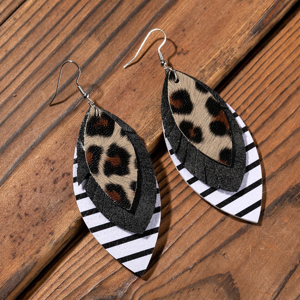 Layered faux leather statement earrings with leopard print, black, and white stripes.