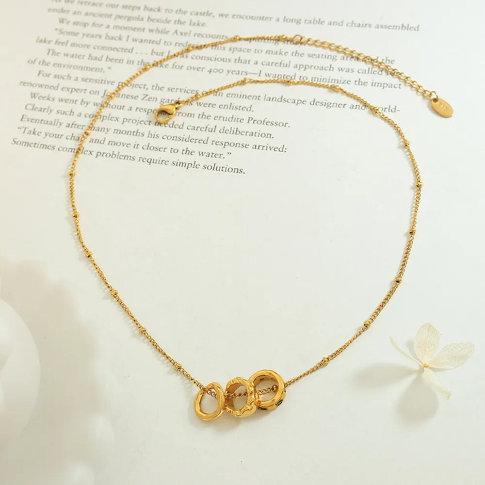 Gold interlocking circle necklace with beaded chain detail