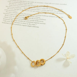 Gold interlocking circle necklace with beaded chain detail
