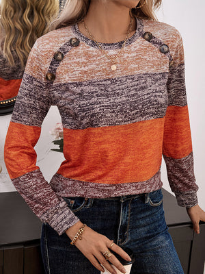 Marled stripe knit sweater with button shoulder detail in orange and brown tones.