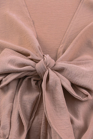 Tie-front blouson sleeve playsuit in Dusty Pink with a knotted V-neck detail.