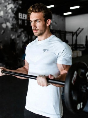 White performance fit raglan sleeve tee with subtle geometric pattern and logo detail