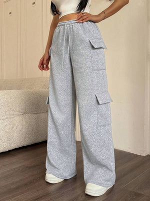 Gray relaxed fit cargo pants with drawstring and multiple pockets.