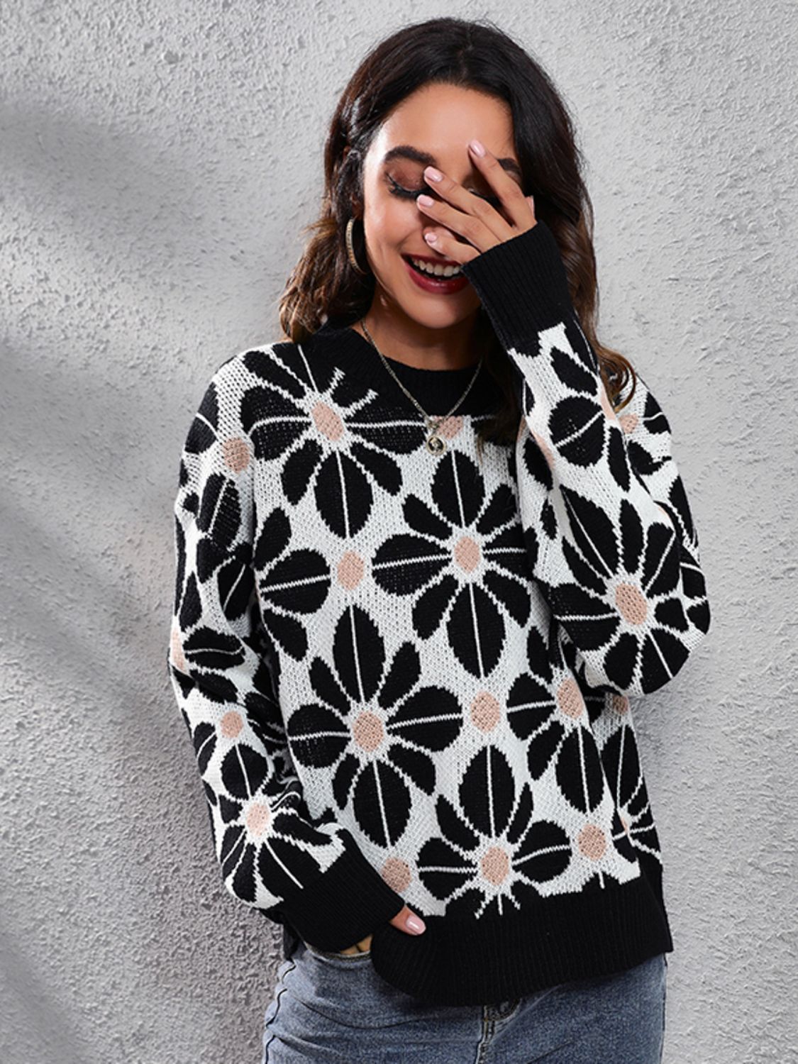 Black acrylic floral jacquard knit sweater with crew neck and long sleeves.