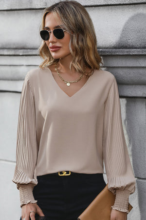 Mocha V-neck blouse with pleated long sleeves and smocked cuffs.