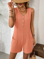 Orange ribbed knit button-front romper with scoop neck, sleeveless, and patch pockets.