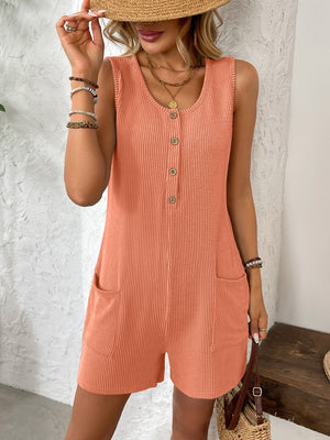 Orange ribbed knit button-front romper with scoop neck, sleeveless, and patch pockets.