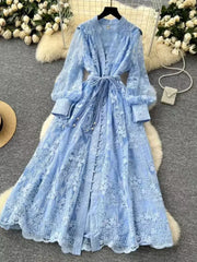 Blue lace maxi dress with tie waist, balloon sleeves, and button-down front.
