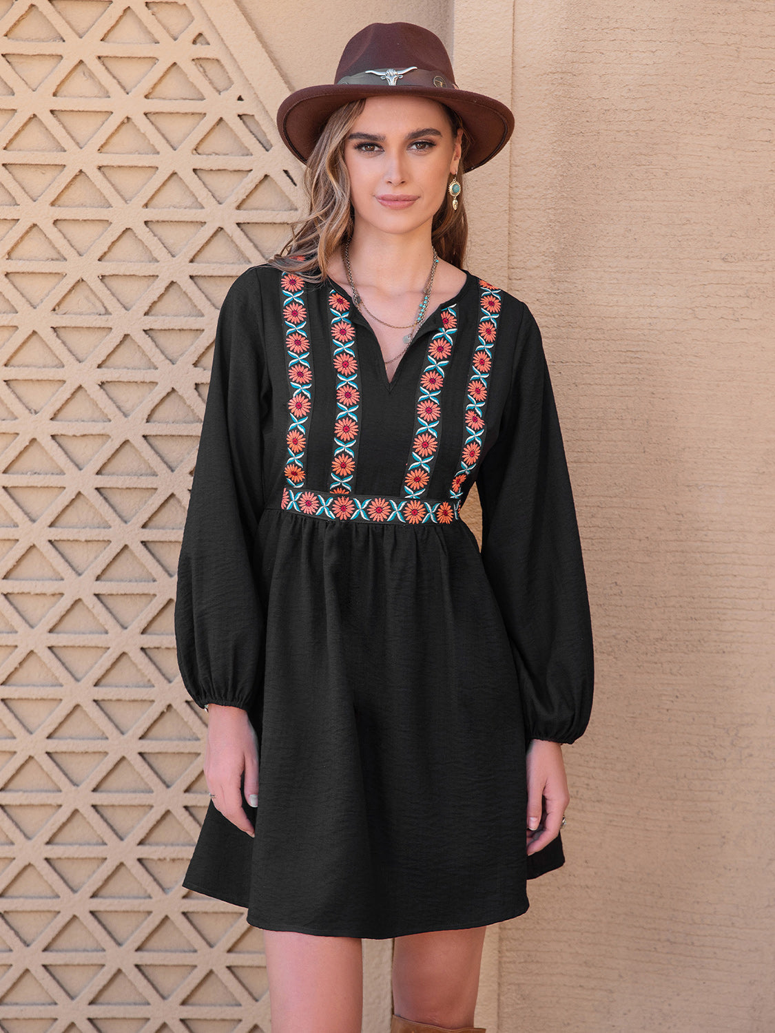 Black mini dress with embroidered yoke and balloon sleeves.