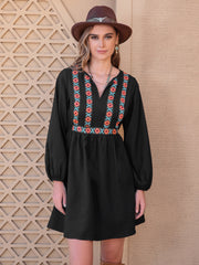 Black mini dress with embroidered yoke and balloon sleeves.
