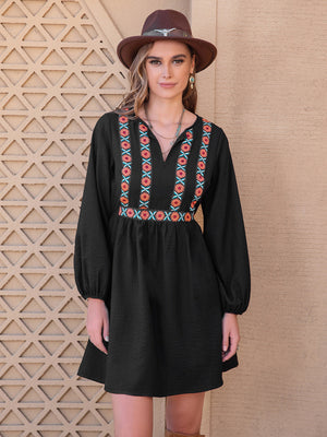 Black mini dress with embroidered yoke and balloon sleeves.