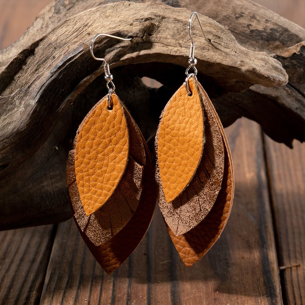 Layered faux leather leaf earrings in brown and tan with textured detail.