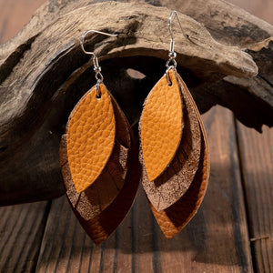 Layered faux leather leaf earrings in brown and tan with textured detail.