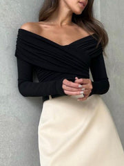 Black off-shoulder bodysuit with long sleeves and ruched detailing.