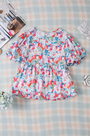 Multicolor watercolor village print peplum blouse with puff sleeves and elasticated waist.