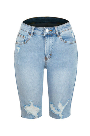 Light wash denim bermuda shorts with distressed details and a raw hem.