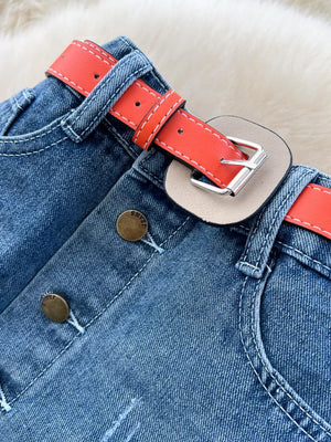 Patchwork denim midi skirt with red belt detail and button front.