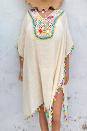 Beige kaftan dress with colorful crochet yoke and tassel trim
