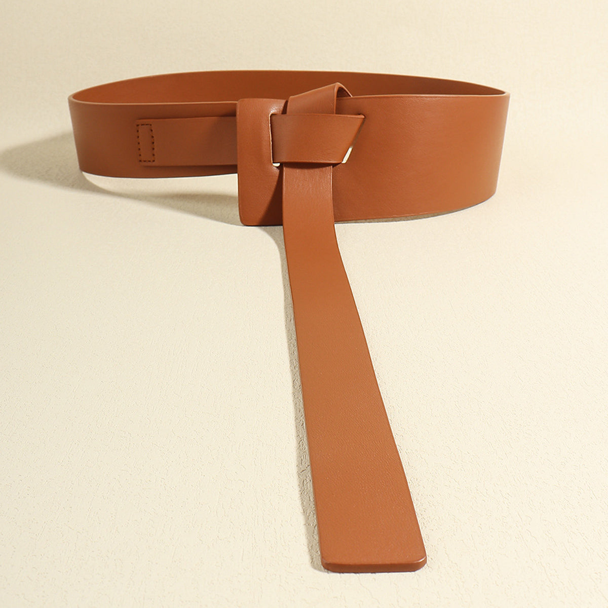 Caramel leather obi belt with a knotted tie and elongated tail detail.