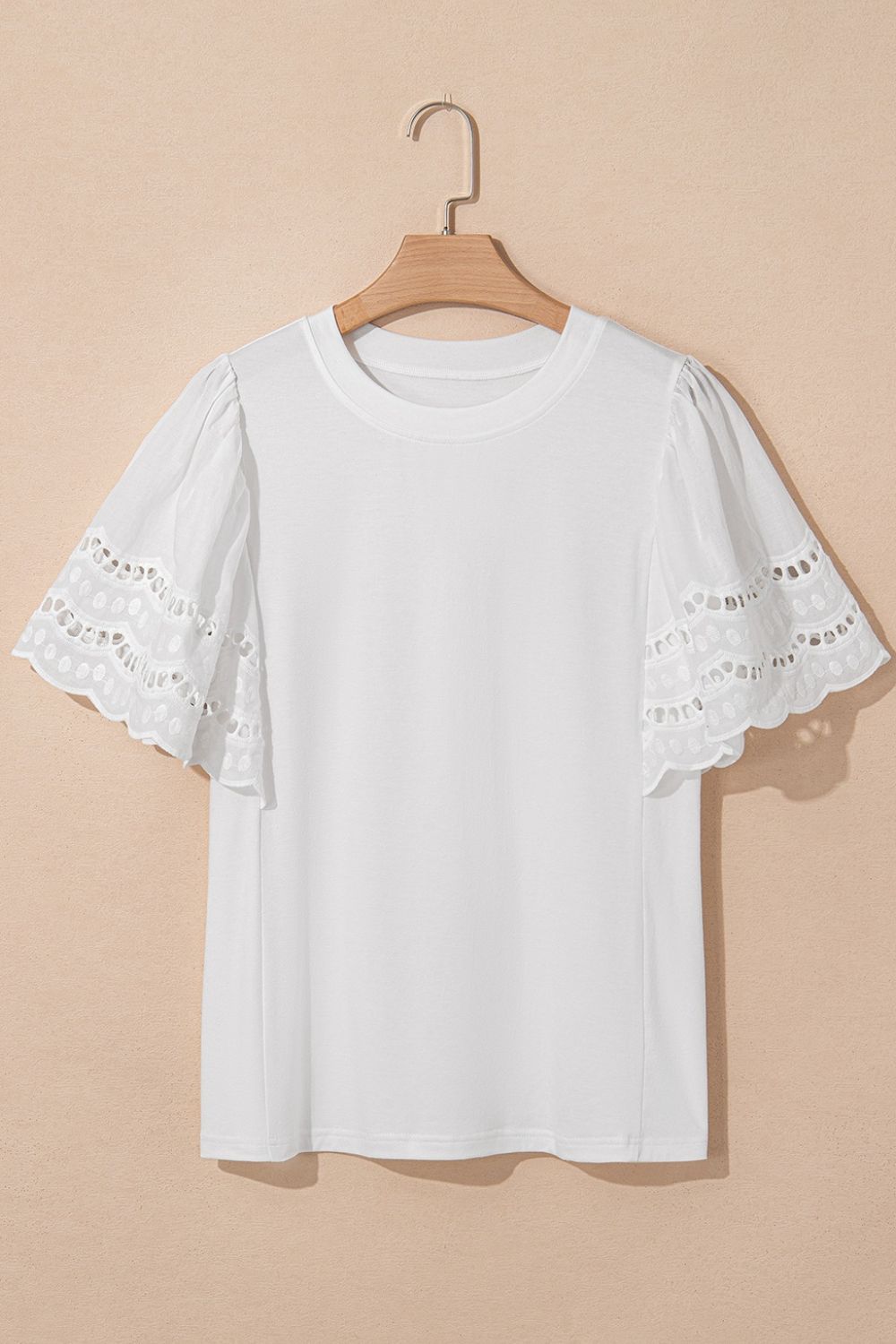 White cotton t-shirt with short flutter sleeves featuring eyelet lace inset details.