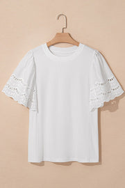 White cotton t-shirt with short flutter sleeves featuring eyelet lace inset details.