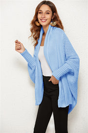 Light blue cocoon knit cardigan with shawl collar and batwing sleeves.