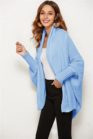 Light blue cocoon knit cardigan with shawl collar and batwing sleeves.