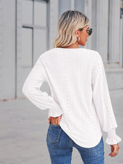 White eyelet lace inset blouse with blouson sleeves and ruffled cuffs.