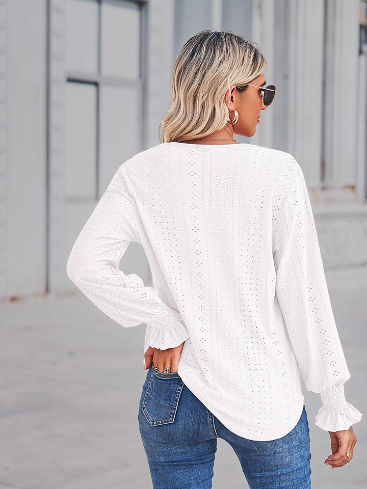 White eyelet lace inset blouse with blouson sleeves and ruffled cuffs.