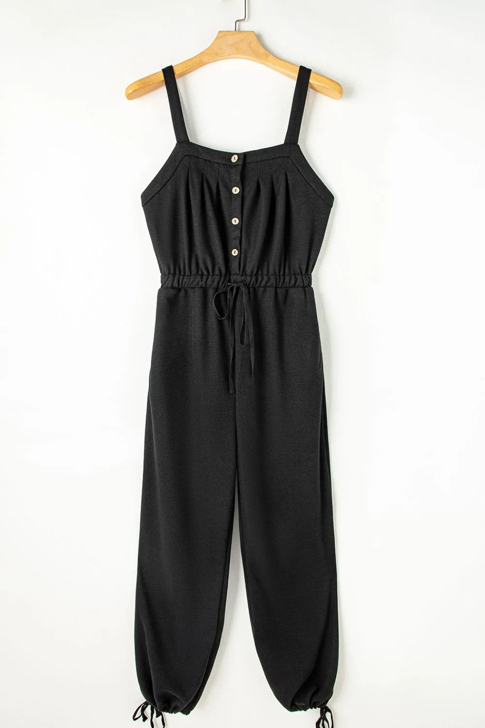Black waffle knit wide leg jumpsuit with button front and drawstring waist
