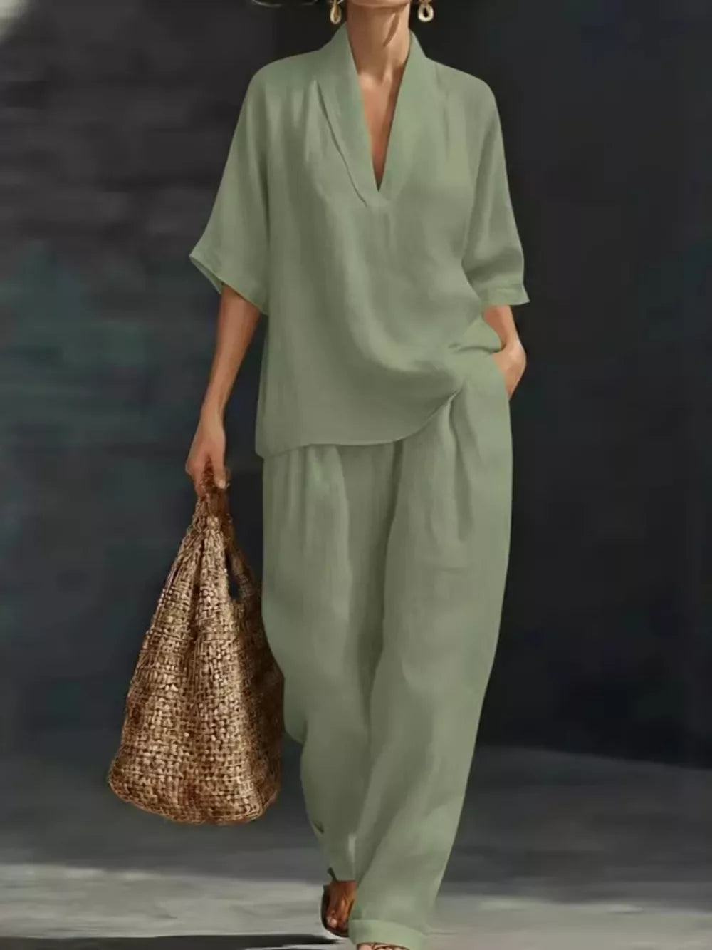 Light green half-sleeve top and wide-leg pants set with V-neck, worn by a woman carrying a straw bag.
