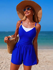 Chic color block one-piece swimsuit in sapphire blue and white with adjustable straps and shorts.