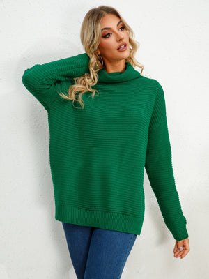Green textured knit oversized turtleneck pullover sweater with ribbed details.
