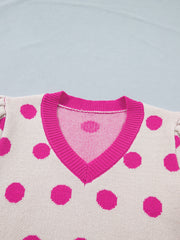 Cream knit top with hot pink polka dots and V-neck with pink trim. Puff sleeves visible.