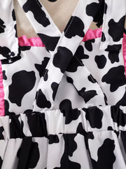 Children's Cow Print Ruffle Jumpsuit in Brown And White, model styling view