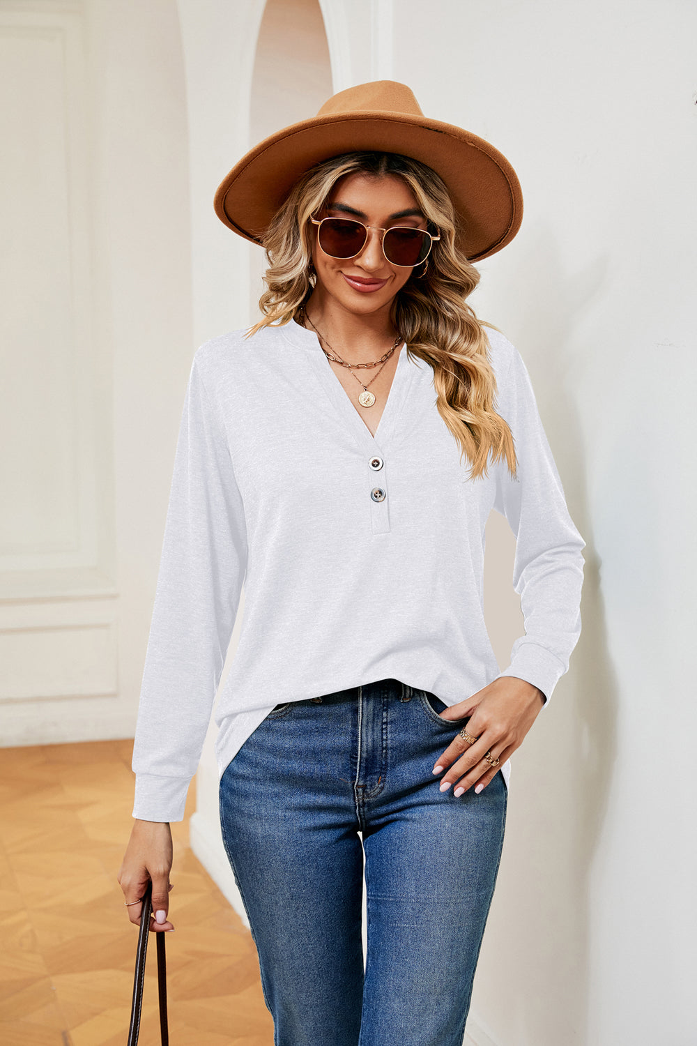 White long sleeve henley top with button detail and v-neck