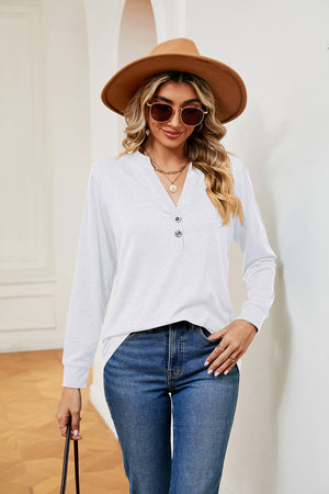 White long sleeve henley top with button detail and v-neck
