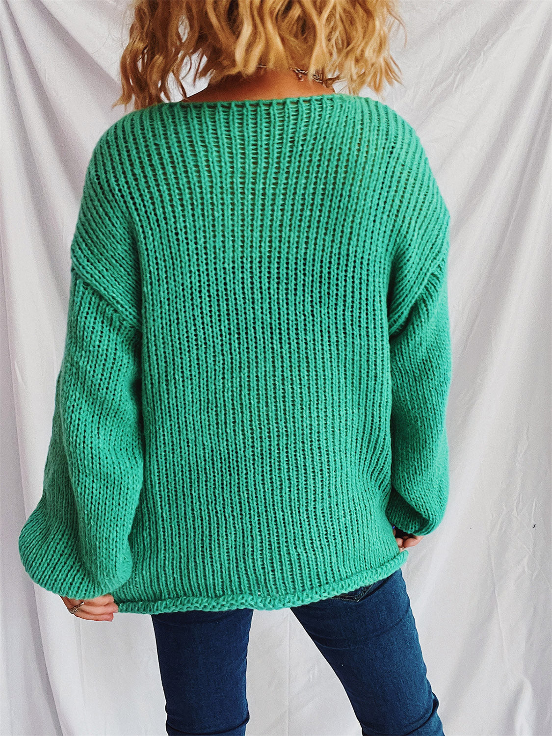 Turquoise open-knit acrylic boatneck pullover sweater with slouchy fit and ribbed details.