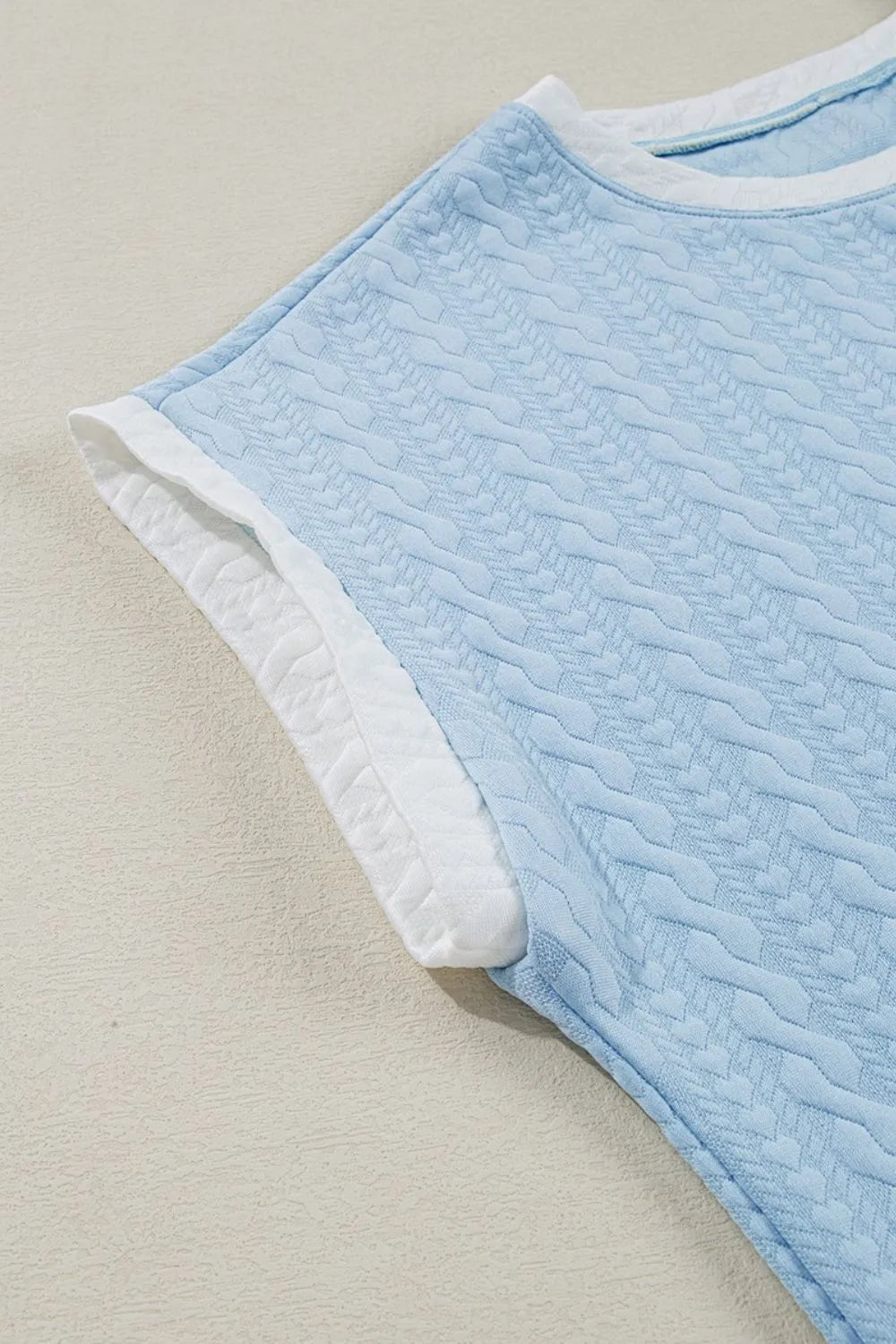 Light blue cable knit loungewear set top with white contrast trim and textured pattern.