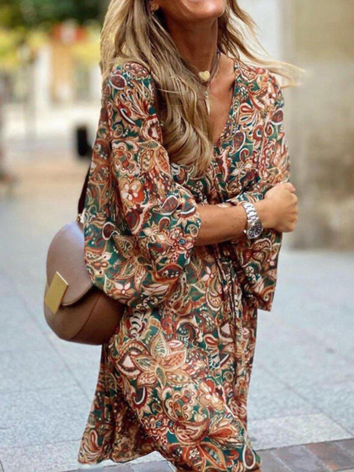 Paisley print balloon sleeve midi dress with V-neck and tie waist in red and brown tones.